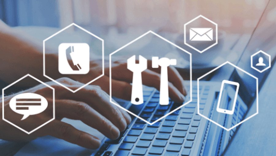 Managed IT service icons floating above a technician working at a laptop